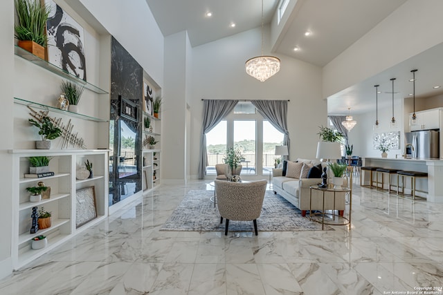 living room with a notable chandelier and high vaulted ceiling