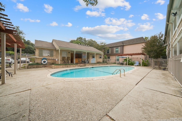 view of swimming pool with a pergola and a patio area