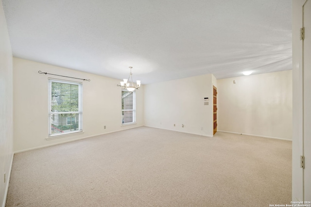 2300 Nacogdoches Rd Unit 232-I, San Antonio, TX 78209 - carpeted empty room featuring baseboards and a notable chandelier