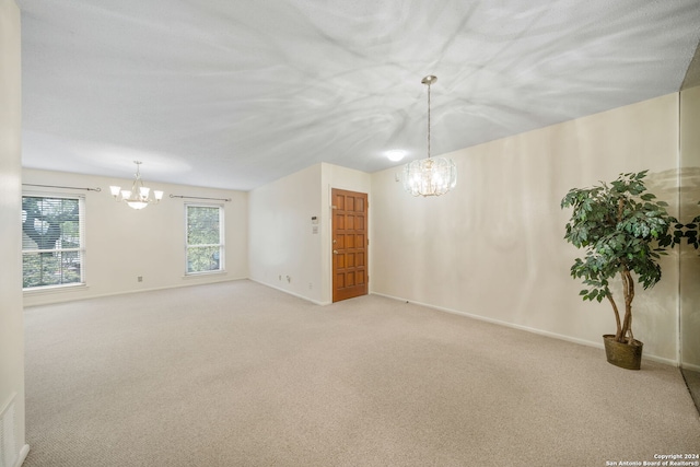 2300 Nacogdoches Rd Unit 232-I, San Antonio, TX 78209 - carpeted spare room featuring baseboards and a notable chandelier