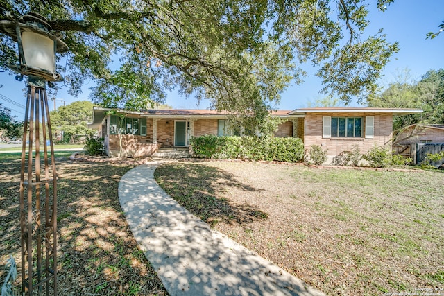 ranch-style house with a front lawn