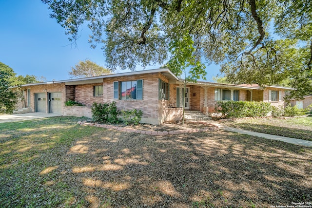 single story home with a front yard and a garage