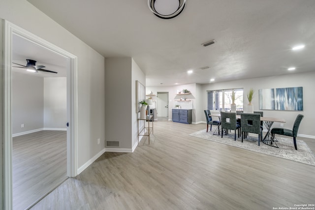 dining area featuring light hardwood / wood-style floors and ceiling fan