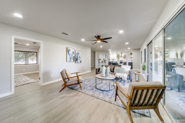 living room with light wood-type flooring and ceiling fan