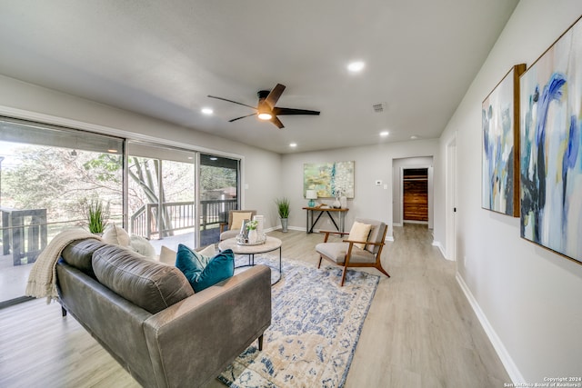 living room featuring light wood-type flooring and ceiling fan