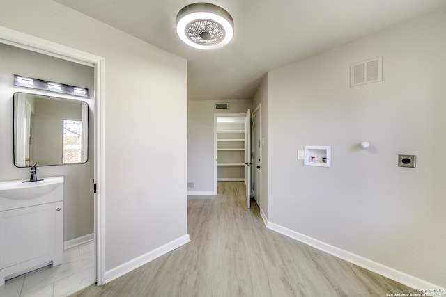 hall featuring light hardwood / wood-style floors and sink