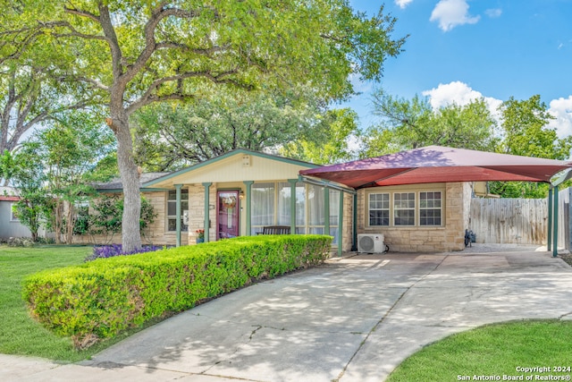 view of front of property with a sunroom and ac unit