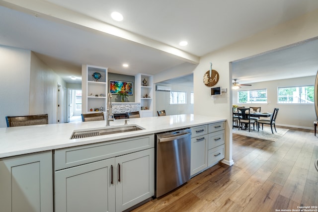 kitchen featuring gray cabinetry, dishwasher, sink, light hardwood / wood-style flooring, and ceiling fan