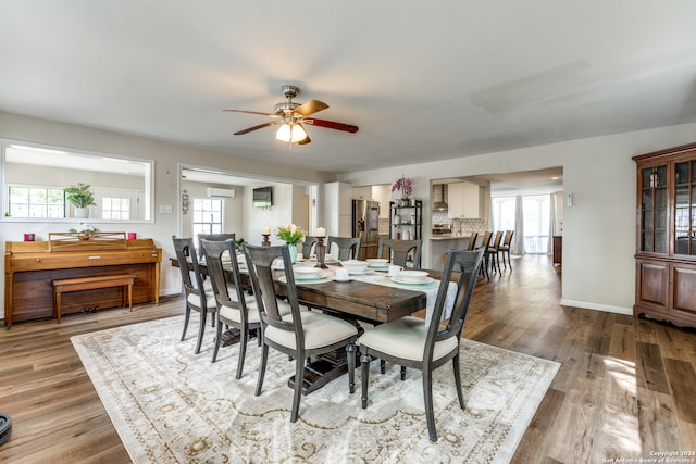 dining room with ceiling fan and wood-type flooring