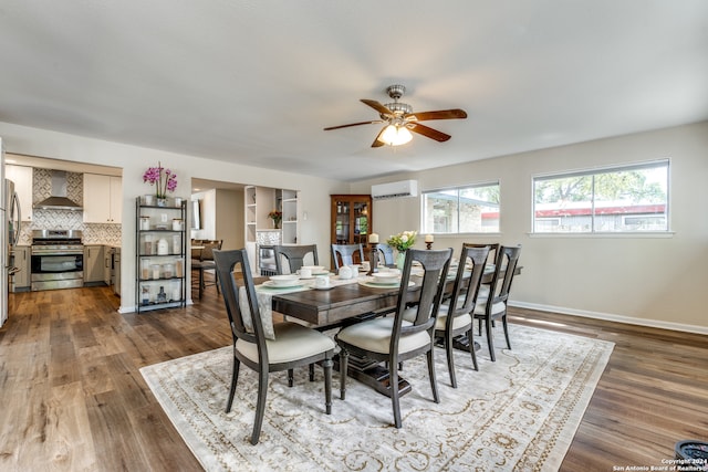 dining room with dark hardwood / wood-style floors, ceiling fan, and a wall mounted AC