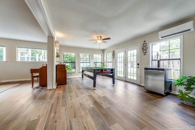 recreation room with ceiling fan, light wood-type flooring, an AC wall unit, and billiards