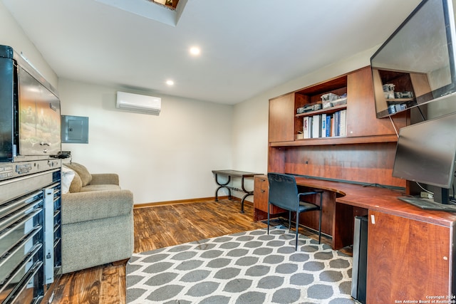 office area with built in desk, dark wood-type flooring, electric panel, and a wall mounted AC