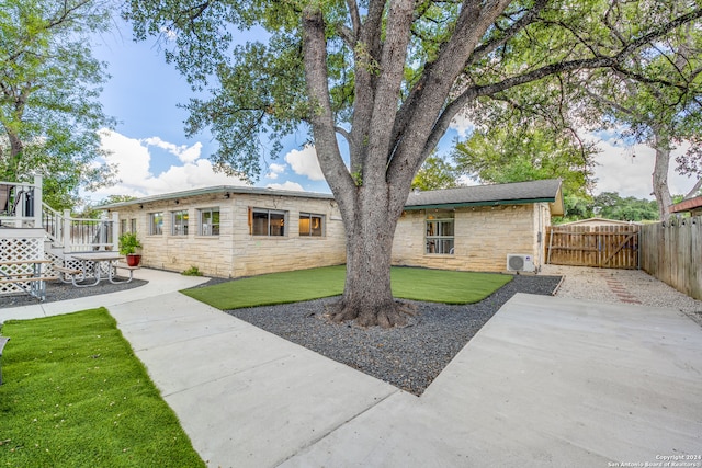 rear view of property featuring a patio area and a yard