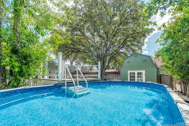 view of swimming pool featuring a wooden deck