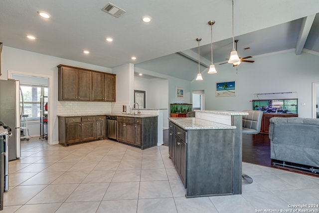 kitchen with lofted ceiling with beams, kitchen peninsula, hanging light fixtures, appliances with stainless steel finishes, and ceiling fan