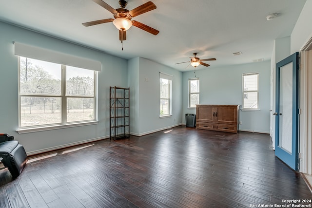 interior space with ceiling fan and dark hardwood / wood-style floors