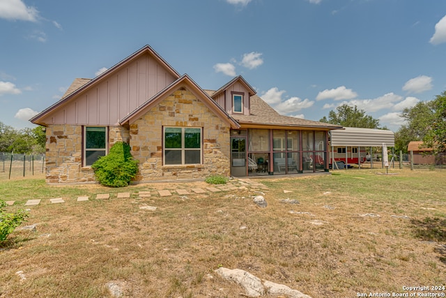 view of front facade featuring a sunroom and a front yard