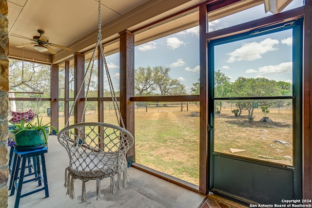 sunroom featuring ceiling fan and a wealth of natural light