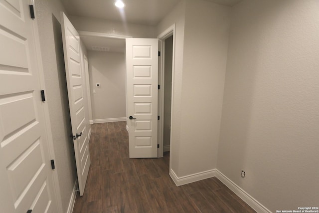 hallway with dark wood-type flooring