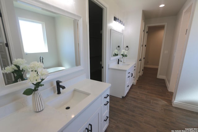 bathroom with vanity and hardwood / wood-style floors