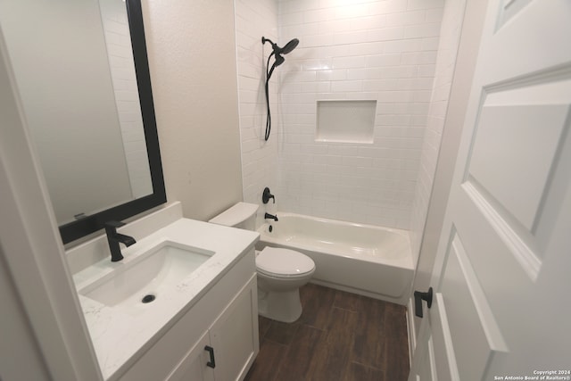 full bathroom with hardwood / wood-style floors, vanity, toilet, and tiled shower / bath combo