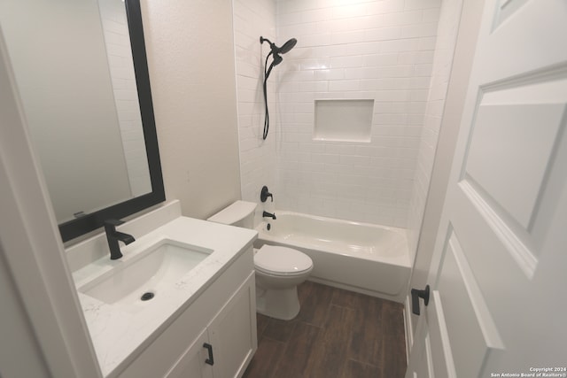 full bathroom with tiled shower / bath, vanity, toilet, and hardwood / wood-style flooring