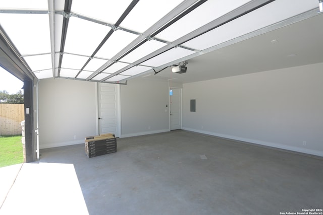 garage with a garage door opener and electric panel