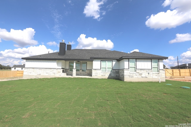 rear view of house with a lawn