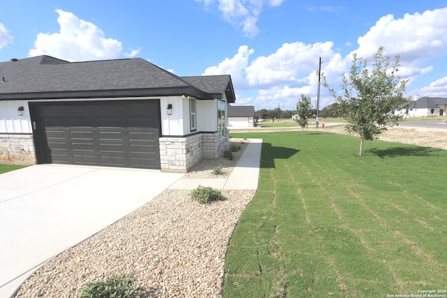 view of property exterior featuring a yard and a garage