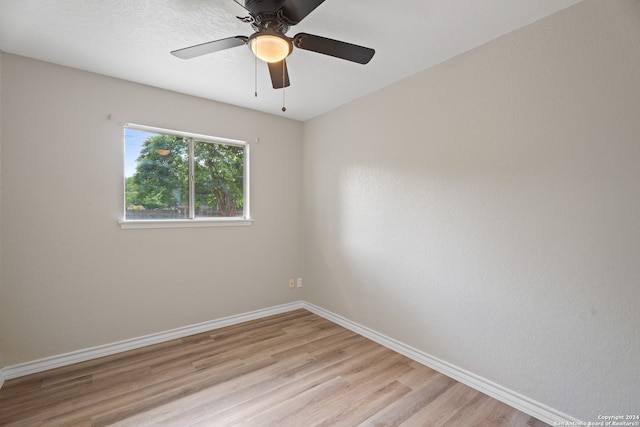 spare room featuring ceiling fan and light hardwood / wood-style floors