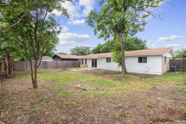 rear view of house with central AC unit