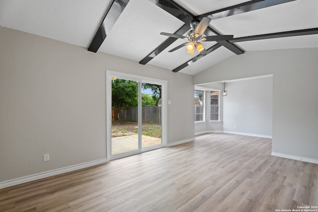 spare room with light wood-type flooring, lofted ceiling with beams, and ceiling fan