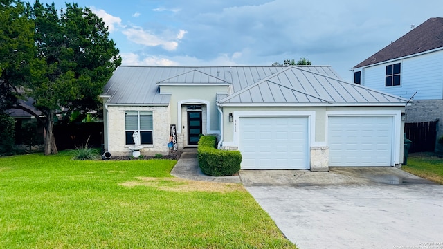 view of front of home with a front yard and a garage