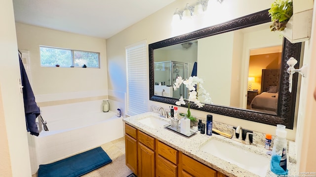 bathroom featuring tile patterned flooring, vanity, and separate shower and tub