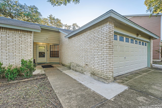 view of exterior entry featuring a garage