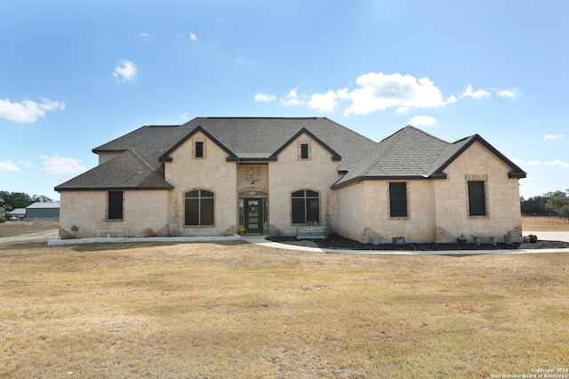 french provincial home featuring a front lawn