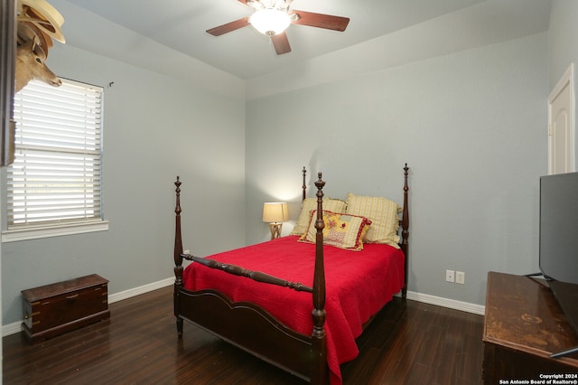 bedroom with dark wood-type flooring and ceiling fan