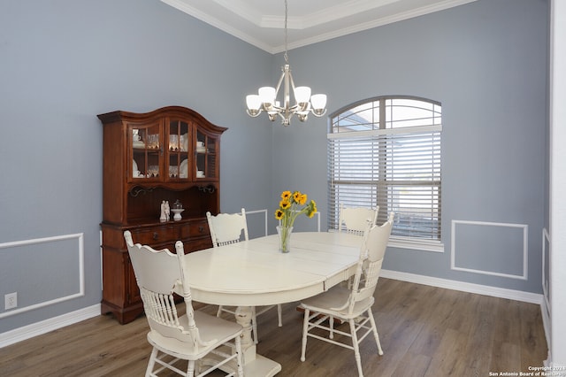 dining space featuring crown molding, dark hardwood / wood-style floors, and a chandelier