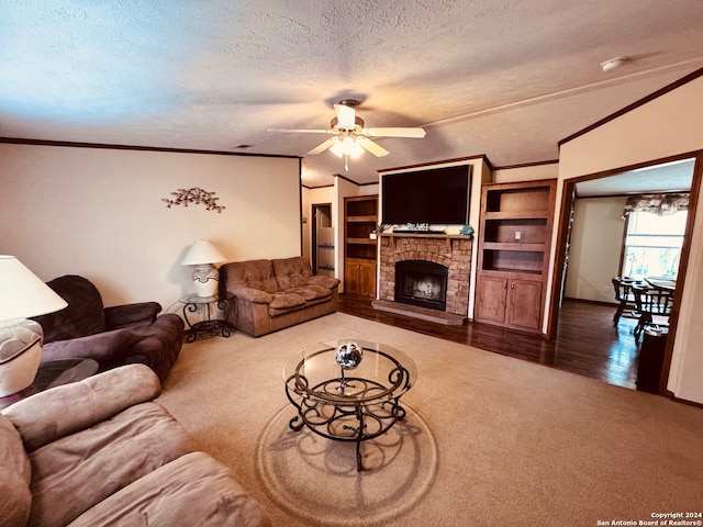 living room featuring ceiling fan, lofted ceiling, a stone fireplace, a textured ceiling, and hardwood / wood-style floors