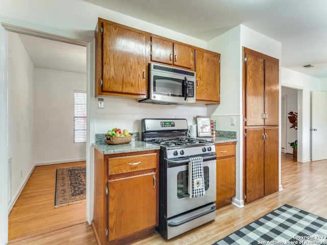 kitchen with light wood-type flooring and appliances with stainless steel finishes