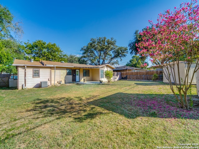 view of yard featuring a patio area, central AC unit, and a storage unit