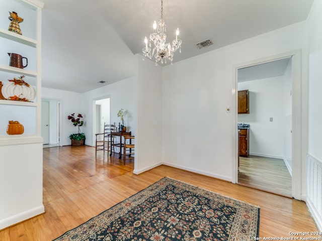 interior space featuring wood-type flooring and a notable chandelier