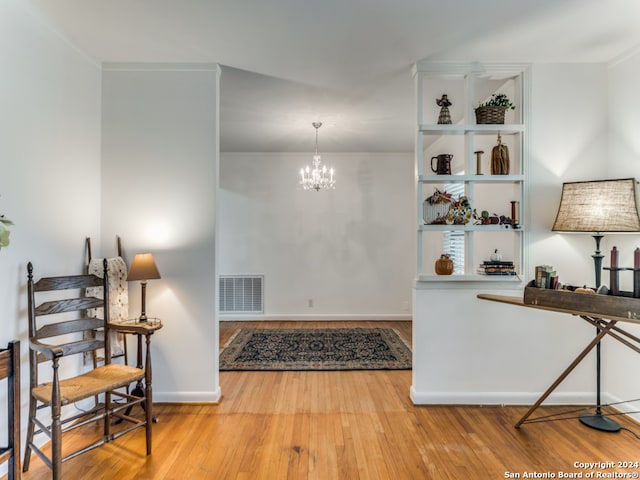 interior space featuring hardwood / wood-style flooring and a chandelier