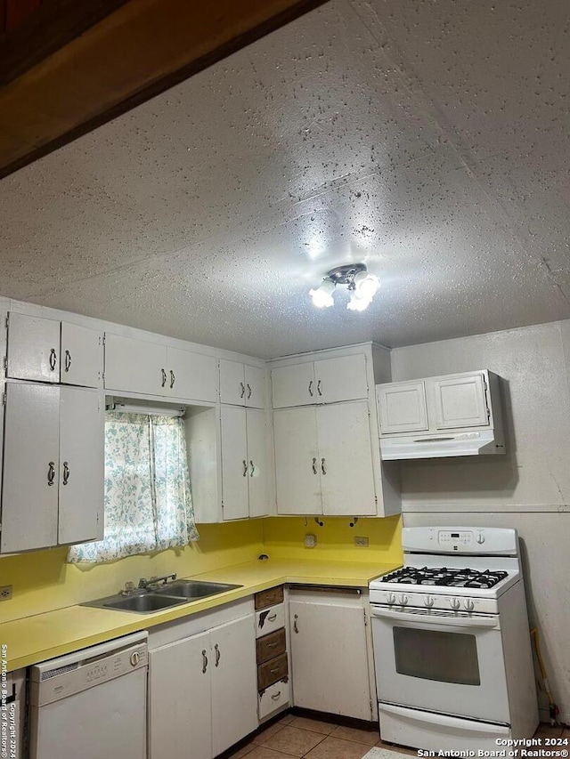 kitchen featuring white cabinets, sink, and white appliances