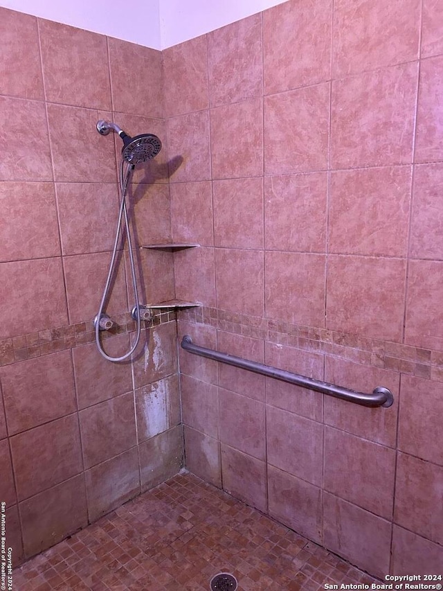 bathroom with a tile shower