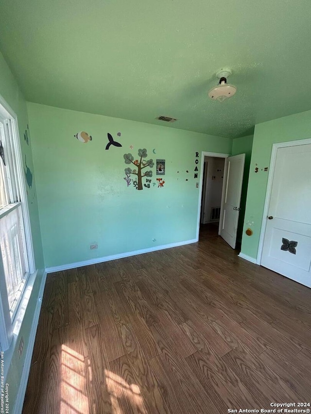 empty room with dark wood-type flooring