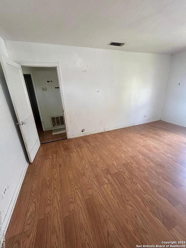 unfurnished room with light hardwood / wood-style floors