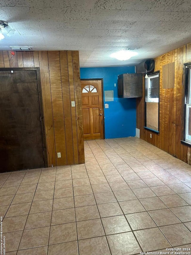 interior space featuring wood walls and a textured ceiling