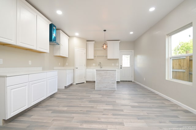 kitchen with white cabinets, pendant lighting, and plenty of natural light