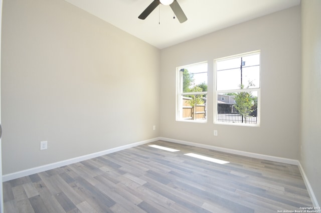 unfurnished room featuring ceiling fan and hardwood / wood-style flooring